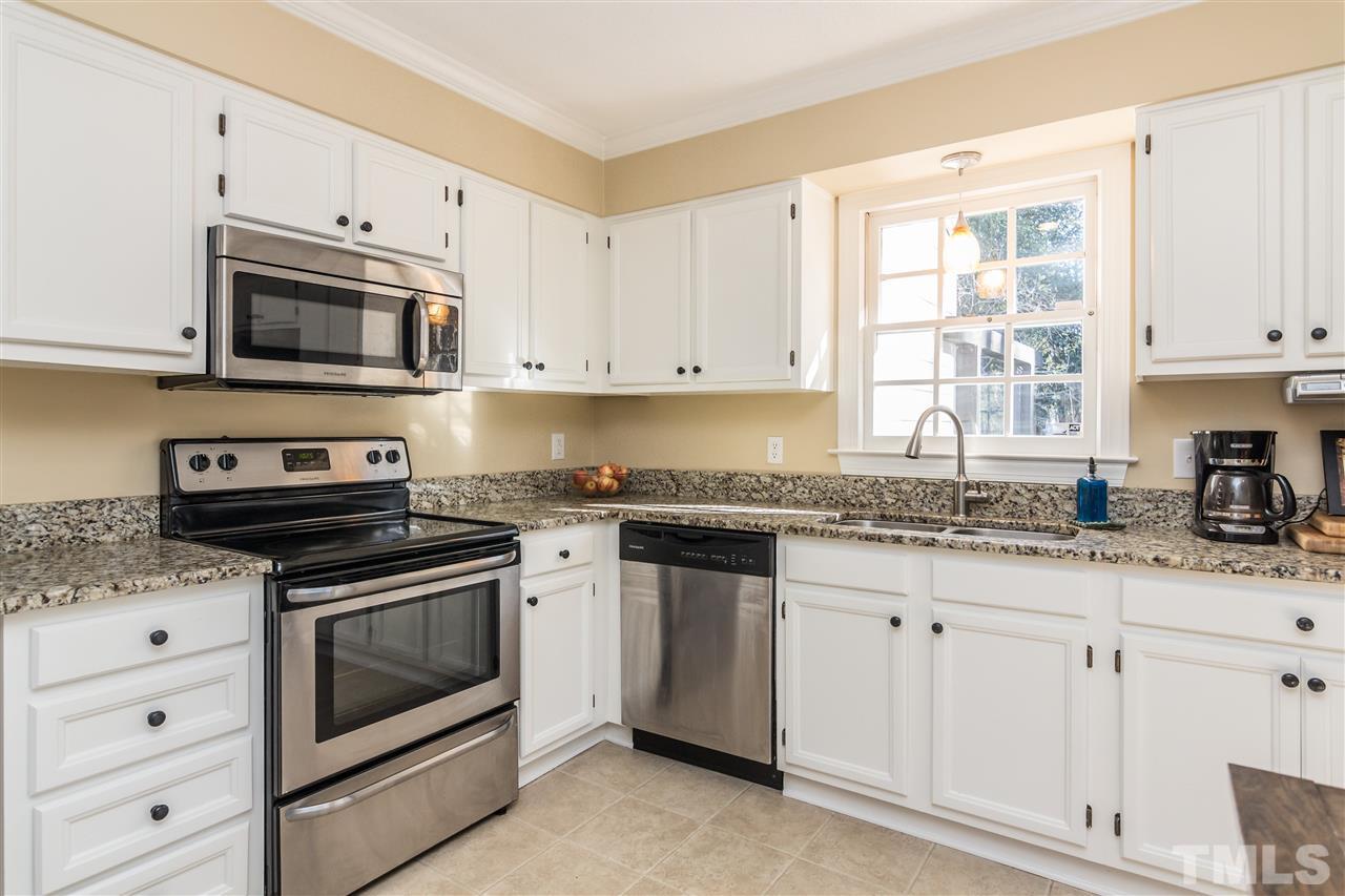 18 Striding Ridge Court Durham, NC 27713 - Photo 9 of 22 a kitchen with granite countertop white cabinets white stainless steel appliances and a sink