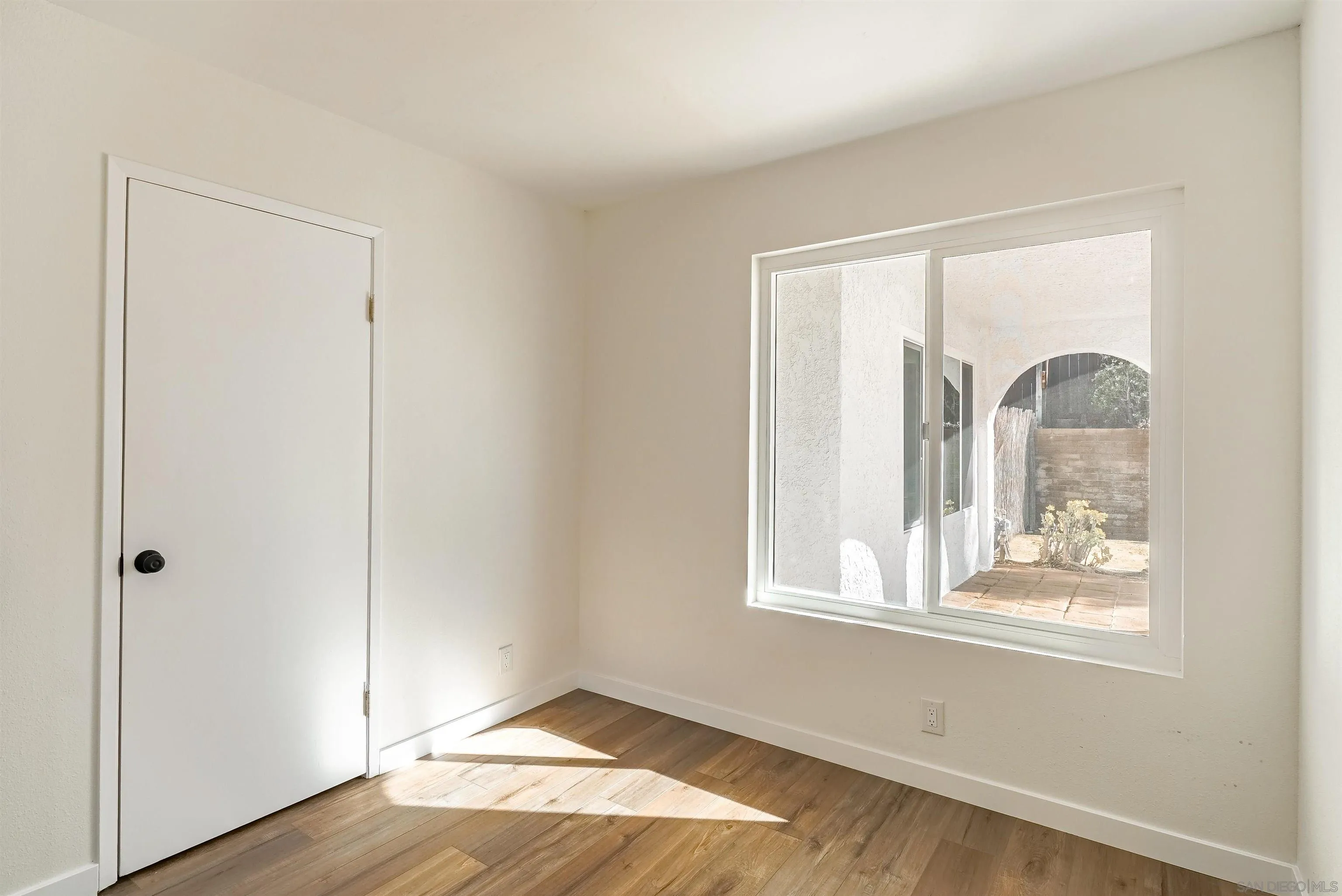 14558 Silla Street Poway, CA 92064 - Photo 13 of 20 a view of an empty room with wooden floor and a window