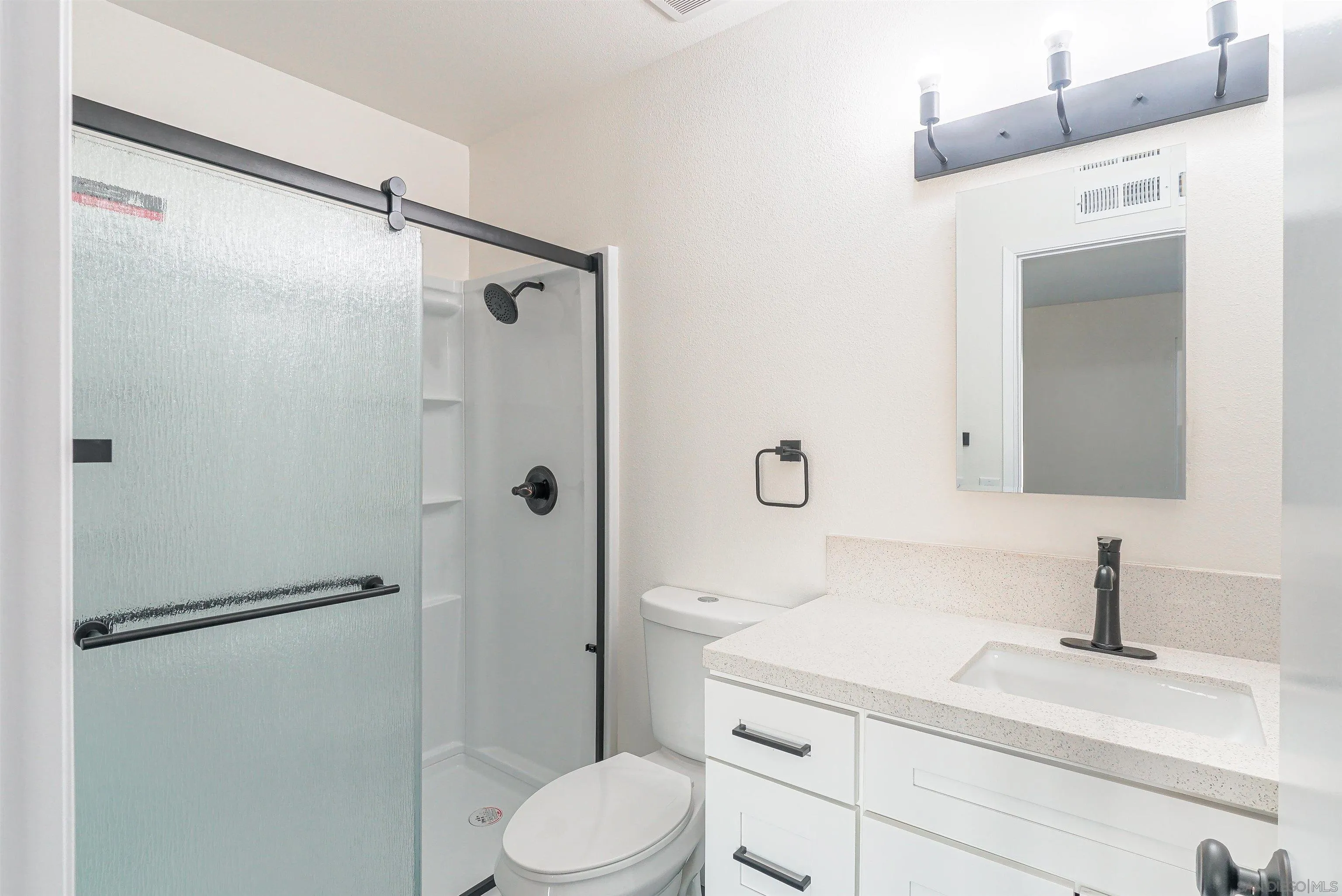 14558 Silla Street Poway, CA 92064 - Photo 16 of 20 a bathroom with a granite countertop sink toilet and shower