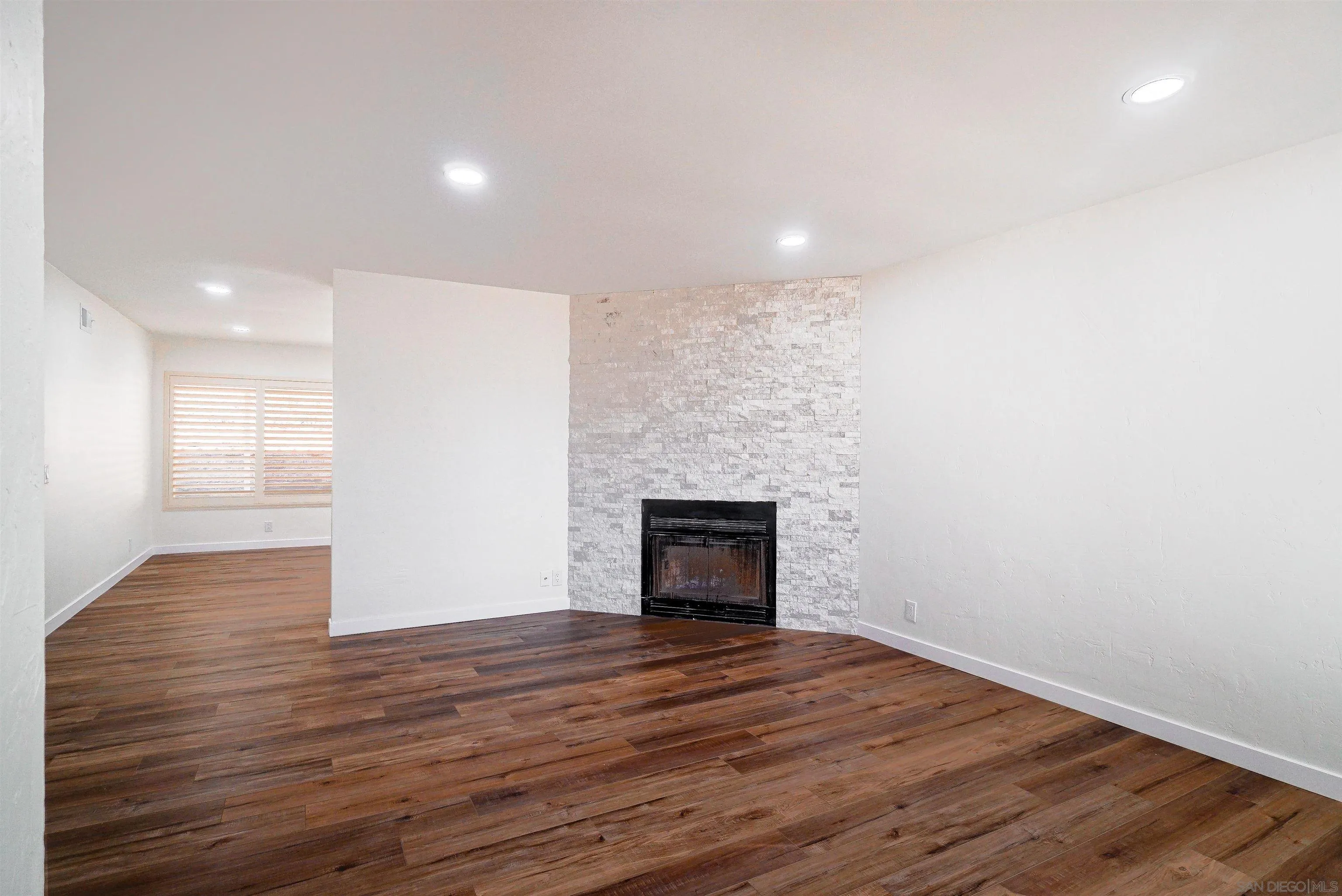 14558 Silla Street Poway, CA 92064 - Photo 2 of 20 an empty room with wooden floor and a fireplace