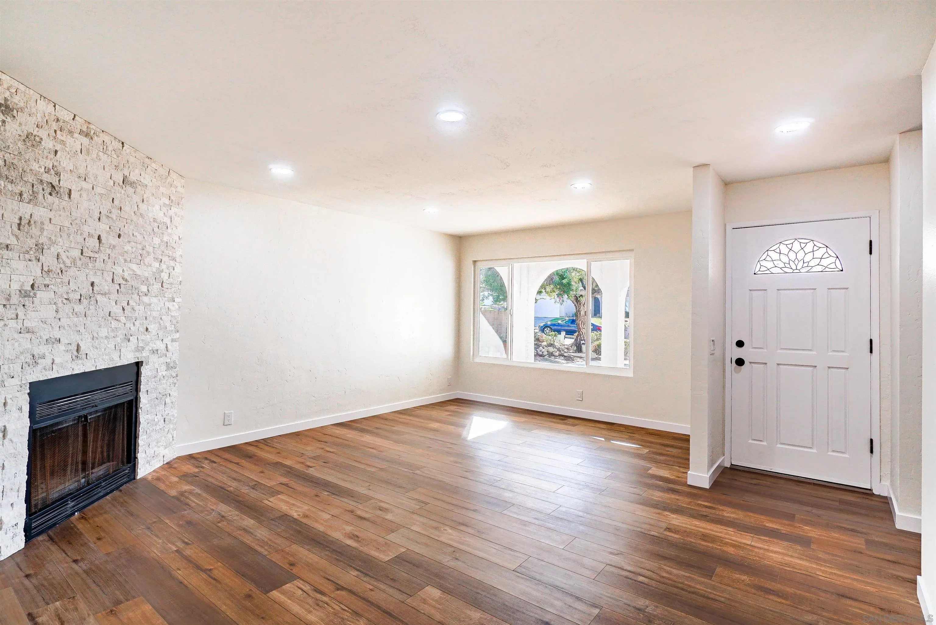14558 Silla Street Poway, CA 92064 - Photo 3 of 20 an empty room with wooden floor and windows