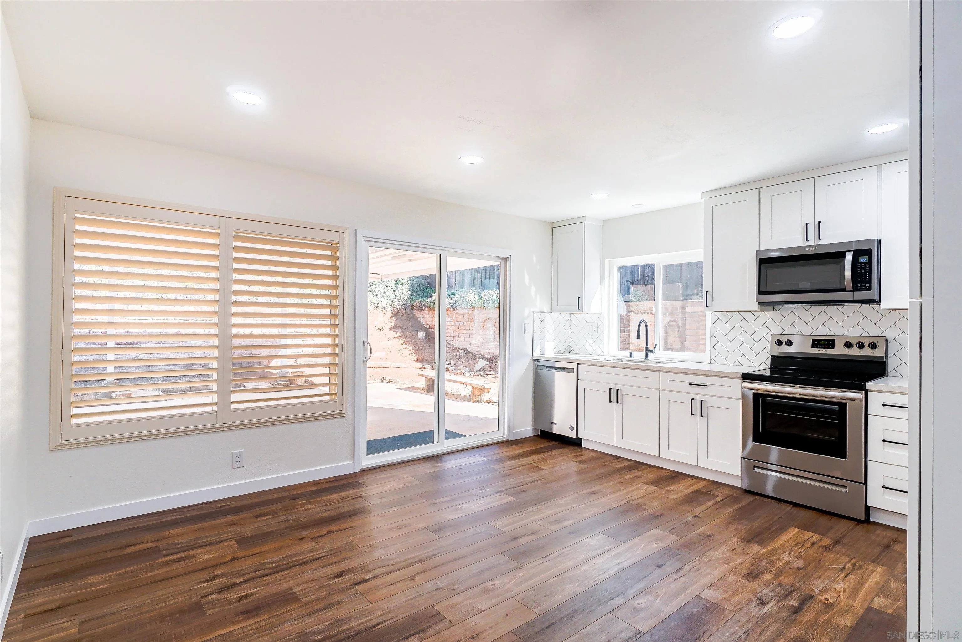14558 Silla Street Poway, CA 92064 - Photo 4 of 20 a large kitchen with a large window a sink and stainless steel appliances