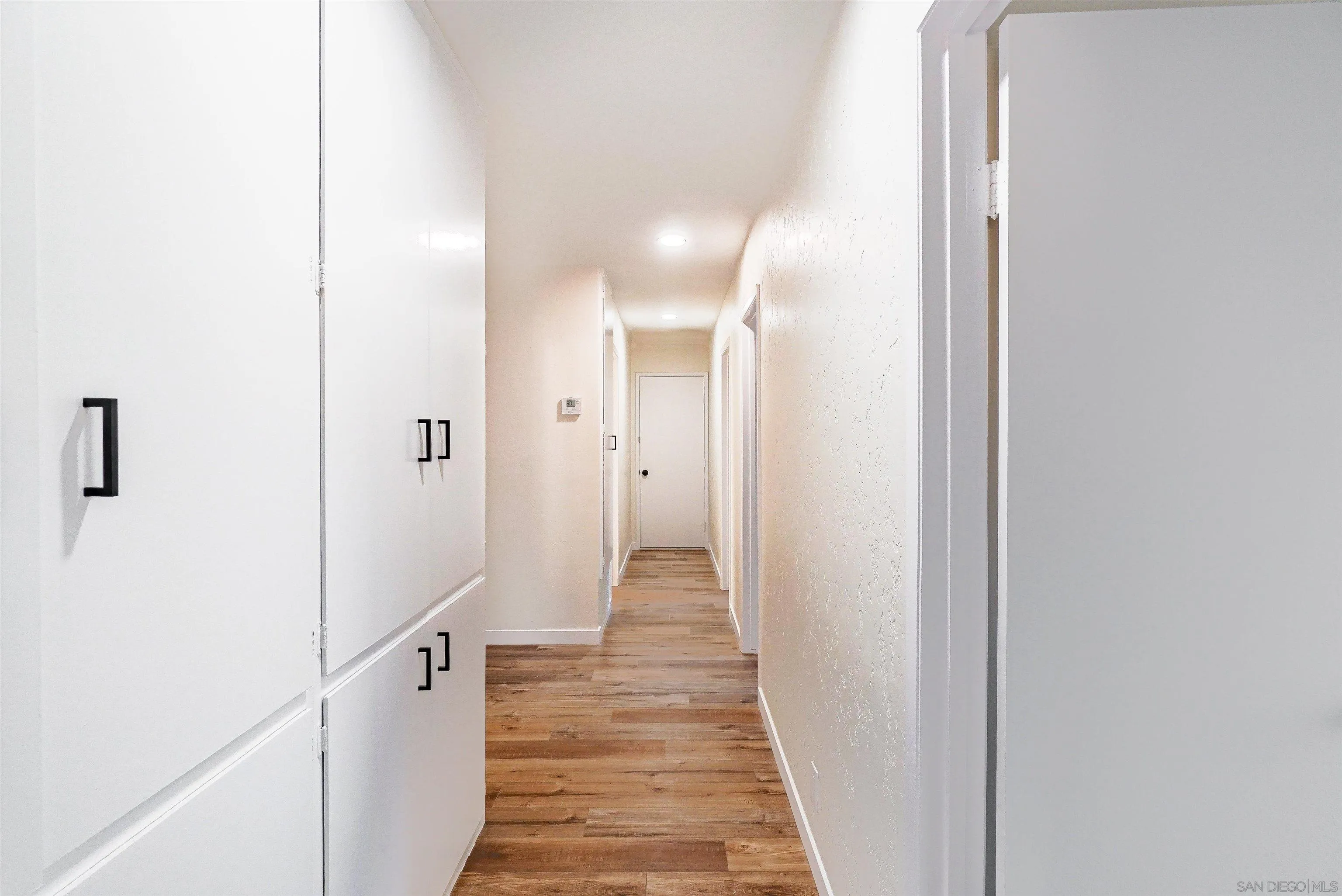 14558 Silla Street Poway, CA 92064 - Photo 7 of 20 a view of a hallway with wooden floor