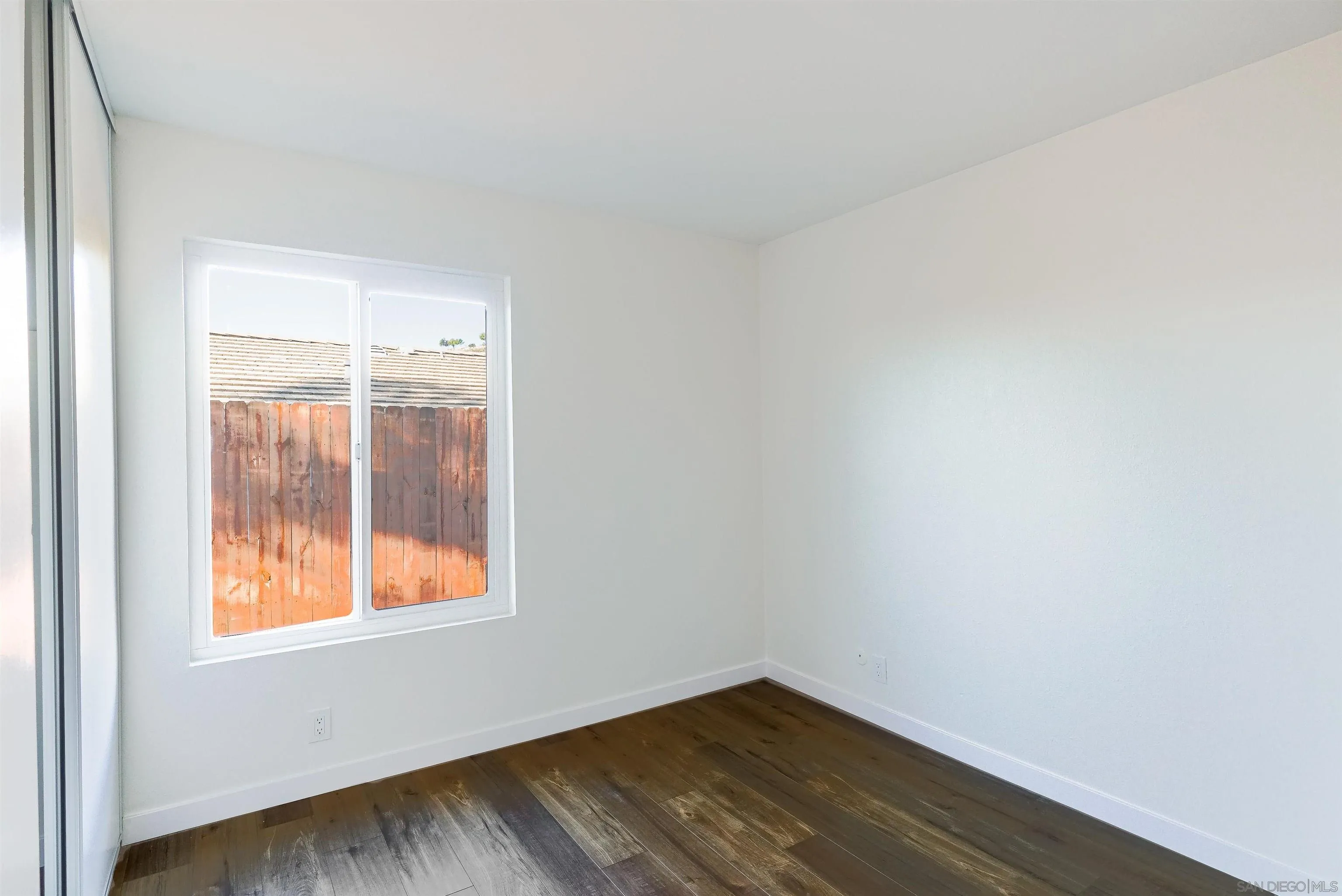 14558 Silla Street Poway, CA 92064 - Photo 10 of 20 a view of an empty room with wooden floor and a window