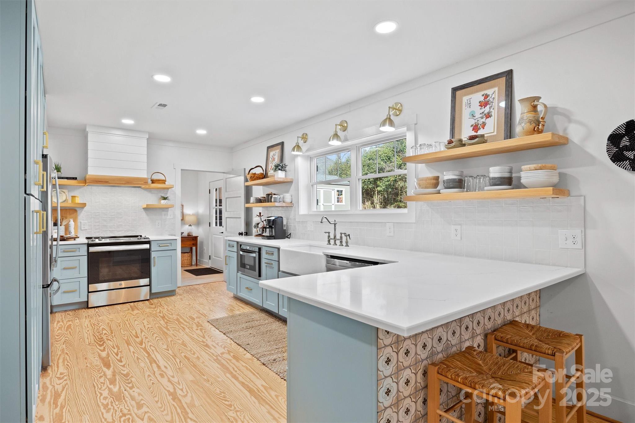 408 Morgan Street Fort Mill, SC 29715 - Photo 9 of 29 a open kitchen with stainless steel appliances a stove top oven a sink dishwasher and a refrigerator with wooden floor