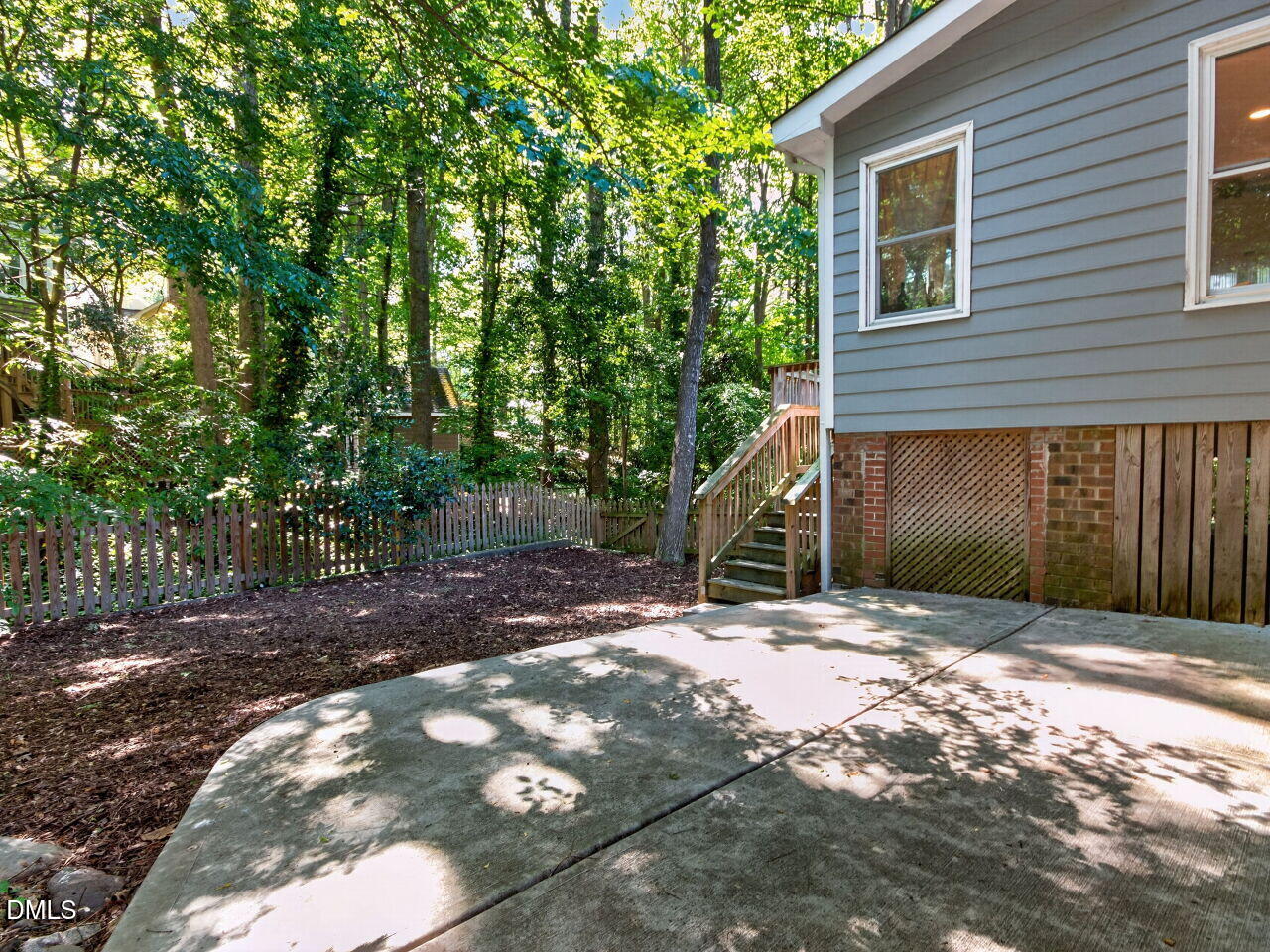6004 Tarnhour Court Raleigh, NC 27612 - Photo 34 of 44 a backyard of a house with lots of green space