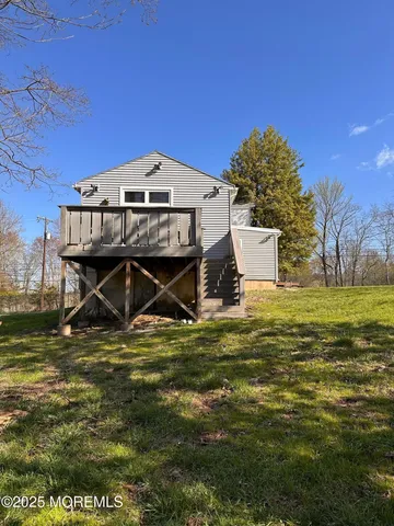 a view of outdoor space with deck and yard