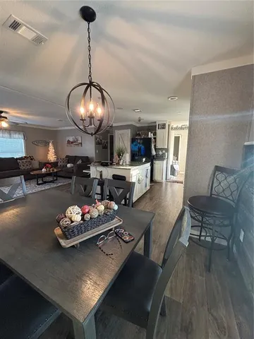 a living room with furniture and kitchen view