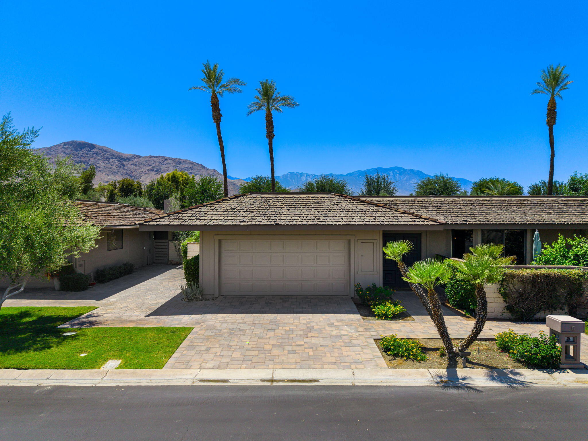 88 Princeton Drive Rancho Mirage, CA 92270 - Photo 31 of 37 a front view of a house with a yard and garage
