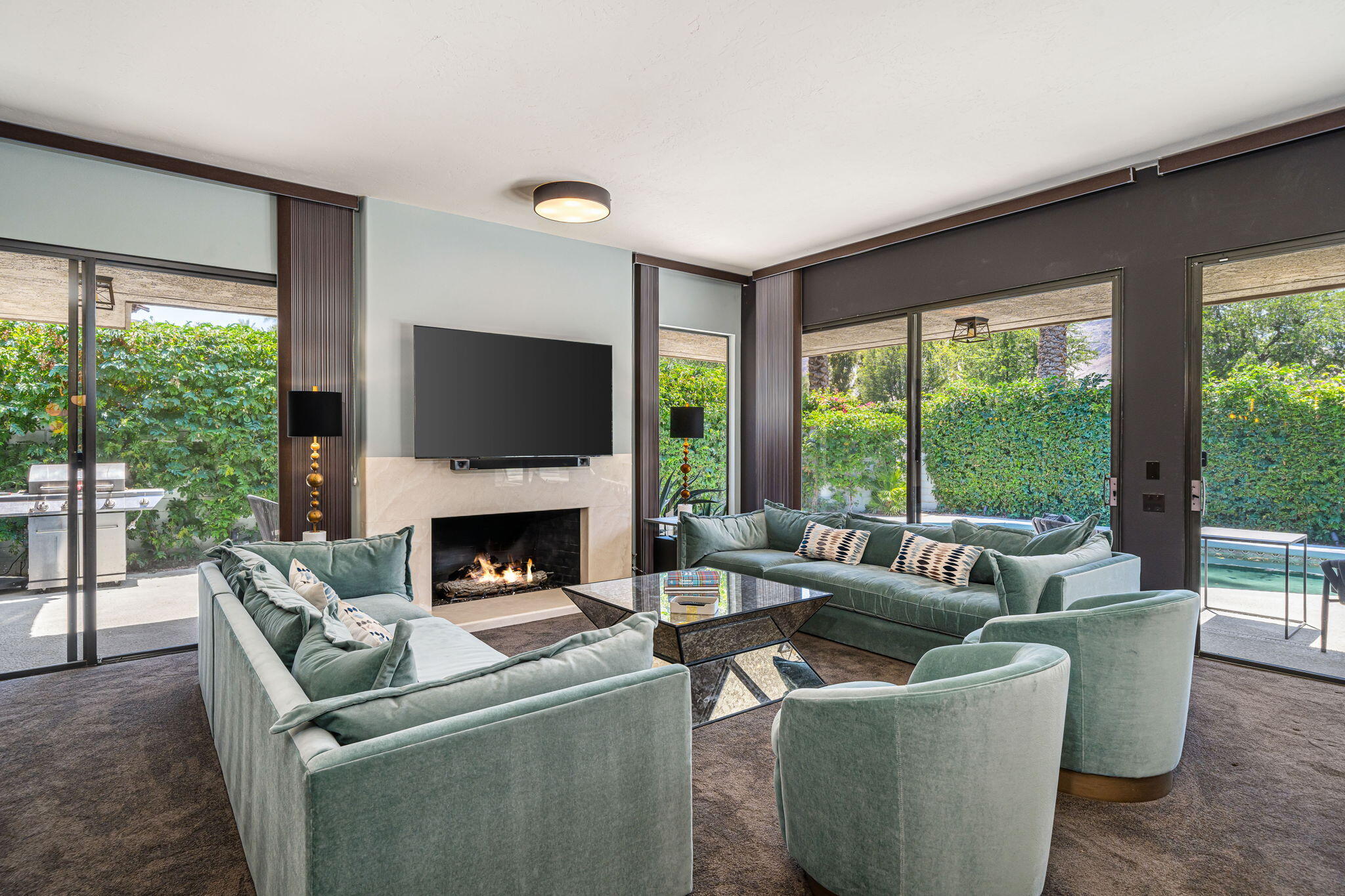 88 Princeton Drive Rancho Mirage, CA 92270 - Photo 4 of 37 a living room with furniture a fireplace and a large window