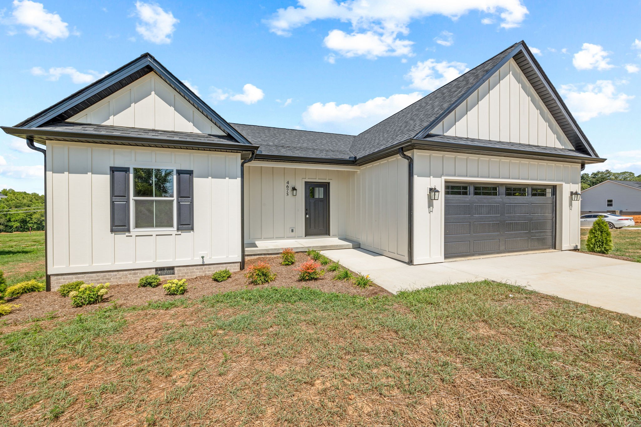 4675 Window Cliff Road Baxter, TN 38544 - Photo 3 of 24 a front view of a house with a yard and garage