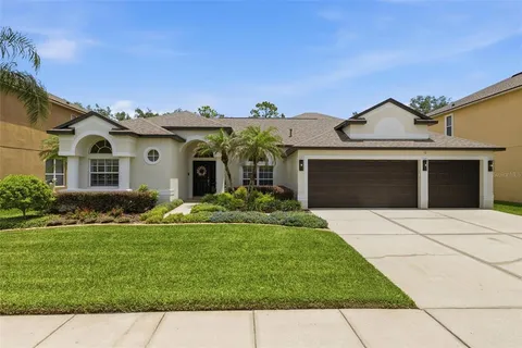 a front view of a house with a garden and yard