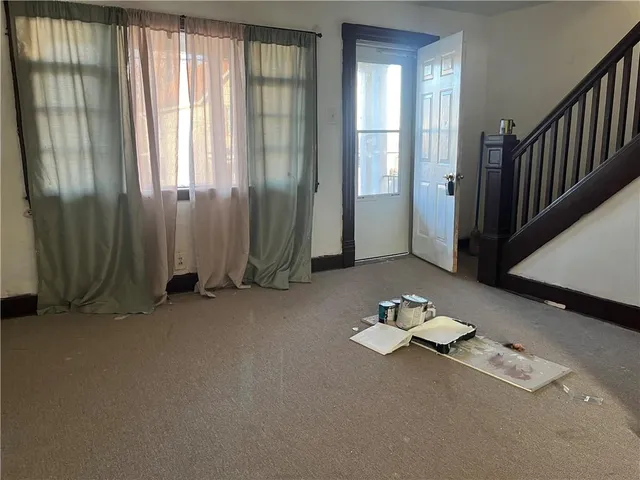 an empty room with windows and closet