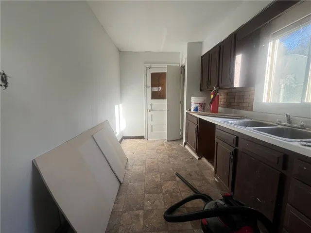 a kitchen with sink cabinets and window