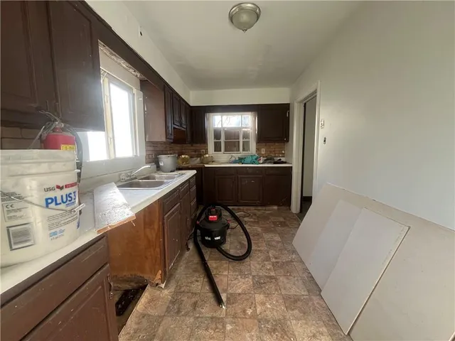 a kitchen with a sink appliances and cabinets