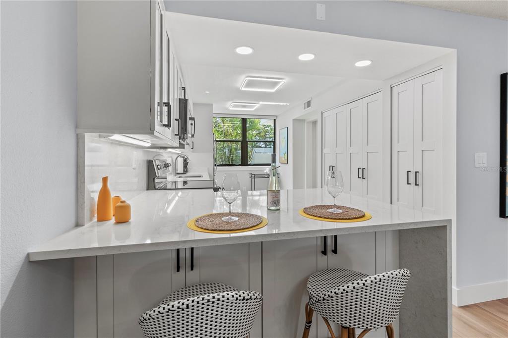 609 Bayport Way, Unit 609 Longboat Key, FL 34228 - Photo 14 of 77 a view of a kitchen area with furniture and window