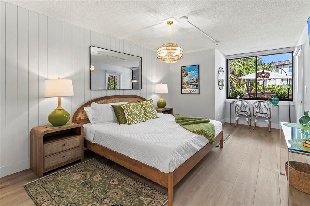 609 Bayport Way, Unit 609 Longboat Key, FL 34228 - Photo 25 of 77 a bedroom with a bed mirror and window