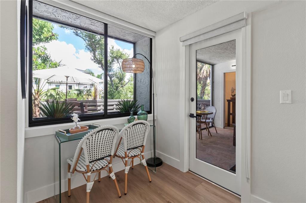 609 Bayport Way, Unit 609 Longboat Key, FL 34228 - Photo 27 of 77 a view of a dining room with furniture window and wooden floor