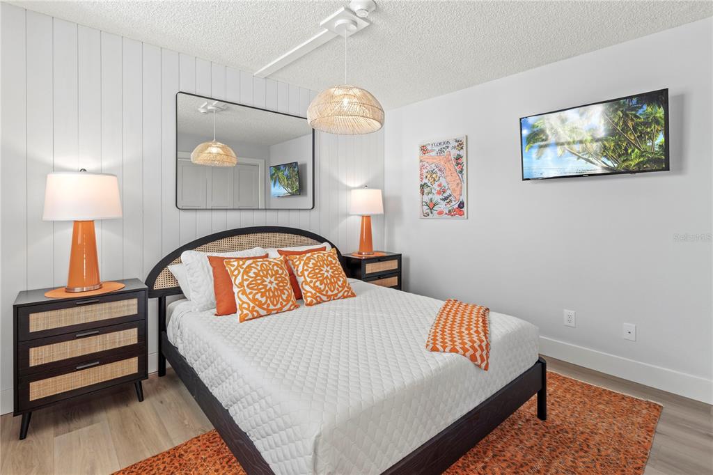 609 Bayport Way, Unit 609 Longboat Key, FL 34228 - Photo 34 of 77 a bedroom with a bed and a lamp on table