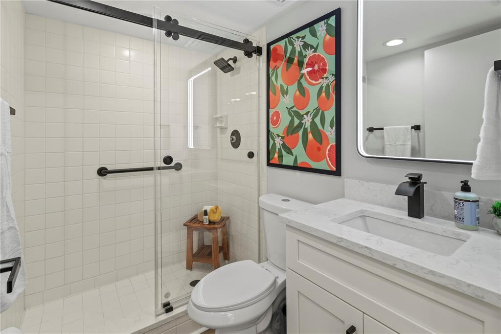 609 Bayport Way, Unit 609 Longboat Key, FL 34228 - Photo 38 of 77 a bathroom with a sink a toilet and shower