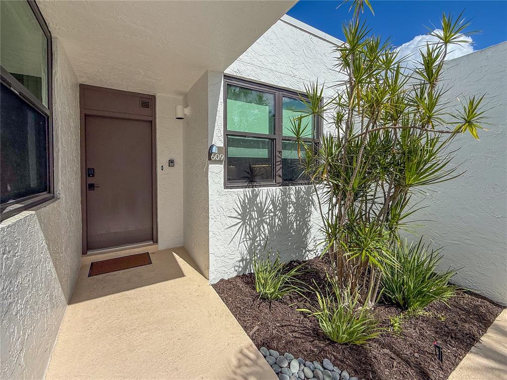 609 Bayport Way, Unit 609 Longboat Key, FL 34228 - Photo 4 of 77 a potted plant in front of a house
