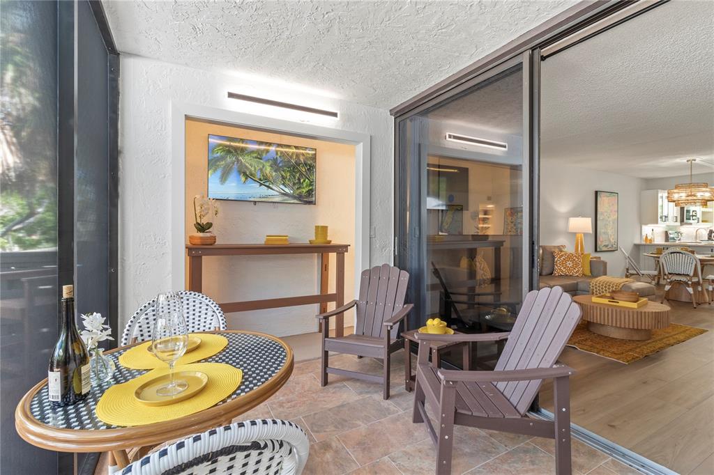 609 Bayport Way, Unit 609 Longboat Key, FL 34228 - Photo 41 of 77 a living room with furniture and a lamp