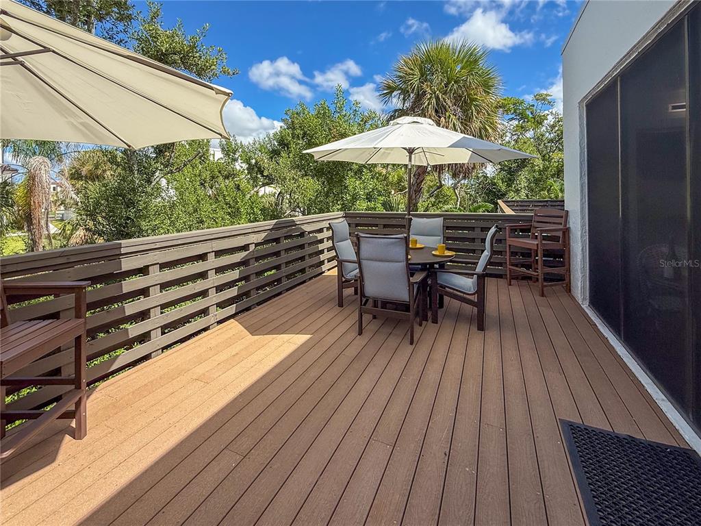 609 Bayport Way, Unit 609 Longboat Key, FL 34228 - Photo 44 of 77 a view of backyard with seating space and wooden floor