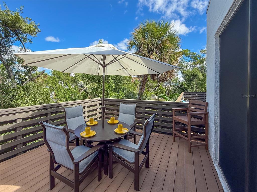 609 Bayport Way, Unit 609 Longboat Key, FL 34228 - Photo 45 of 77 a view of an outdoor space with furniture and umbrella