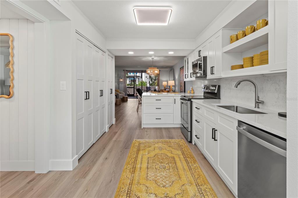609 Bayport Way, Unit 609 Longboat Key, FL 34228 - Photo 10 of 77 a kitchen with a sink appliances cabinets and a counter top space