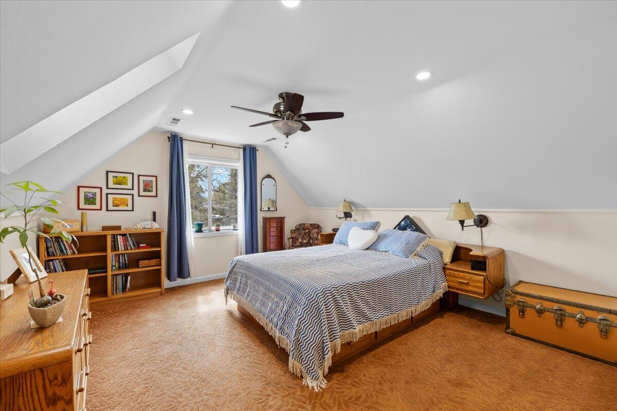 440 Bush Street Central Point, OR 97502 - Photo 25 of 40 a bedroom with a bed and a chandelier