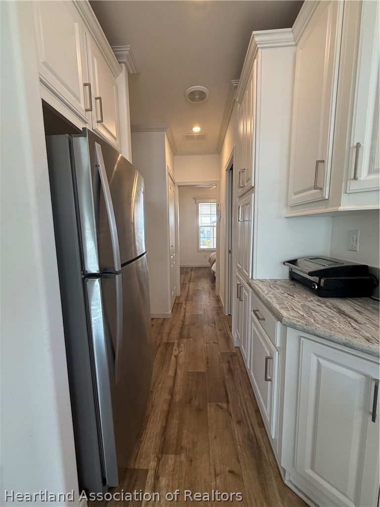 53 Freedom Way Lake Placid, FL 33852 - Photo 15 of 26 a kitchen with stainless steel appliances granite countertop a refrigerator a sink and a stove