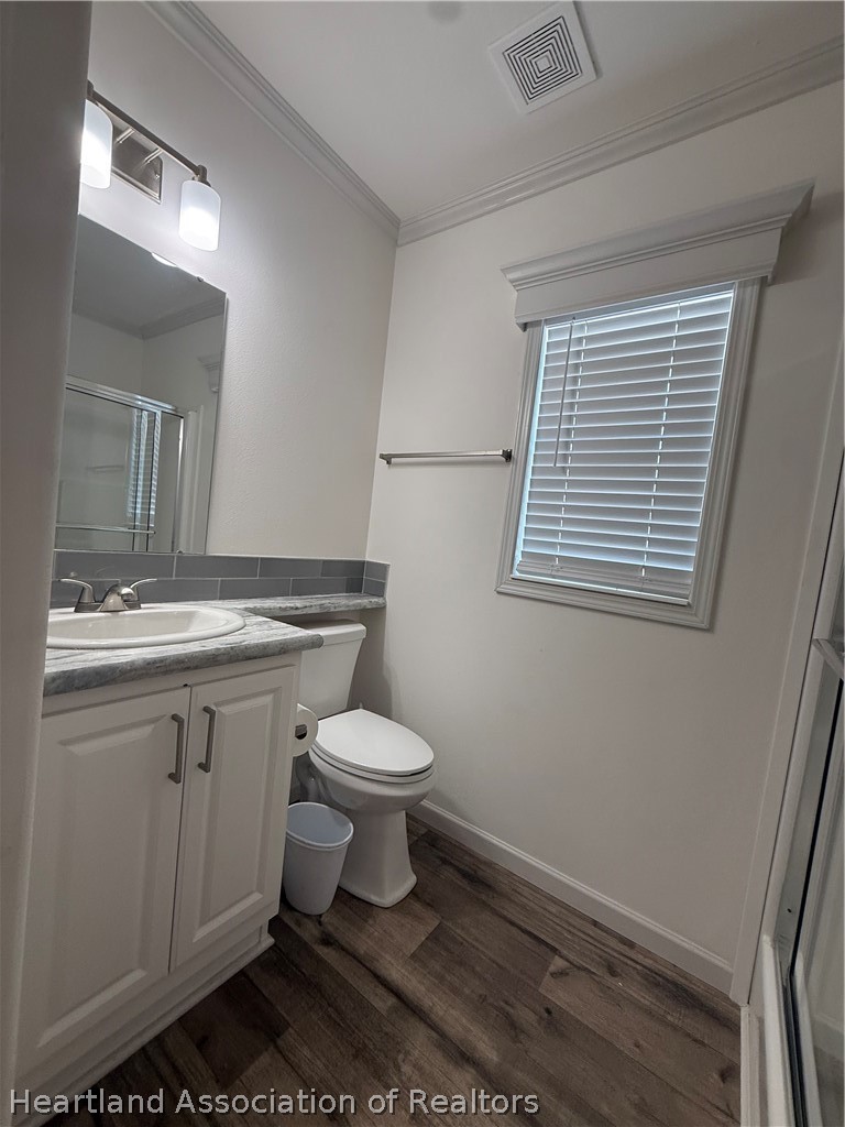 53 Freedom Way Lake Placid, FL 33852 - Photo 18 of 26 a bathroom with a toilet sink and mirror