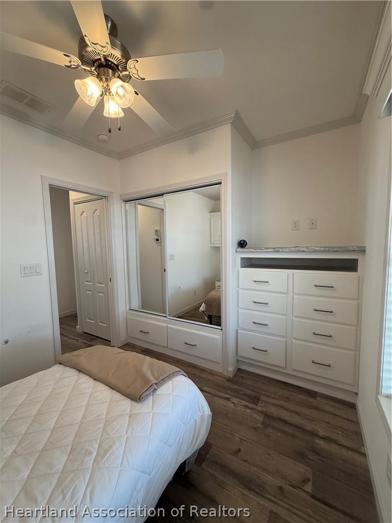 53 Freedom Way Lake Placid, FL 33852 - Photo 20 of 26 a bedroom with a bed and a chandelier