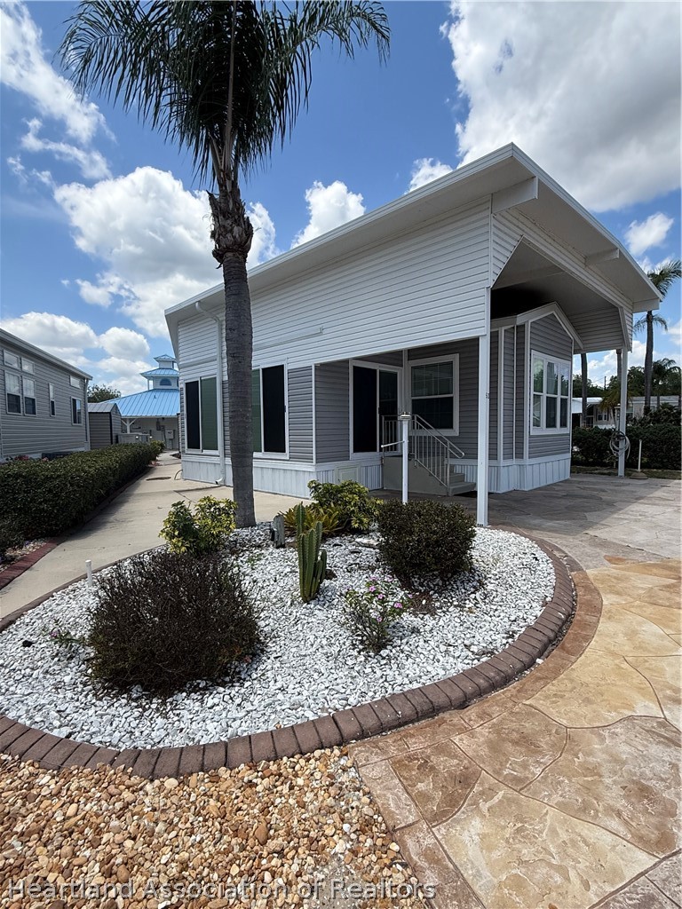 53 Freedom Way Lake Placid, FL 33852 - Photo 3 of 26 a front view of a house with garden