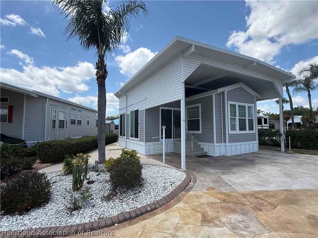 53 Freedom Way Lake Placid, FL 33852 - Photo 4 of 26 a front view of a house with garden