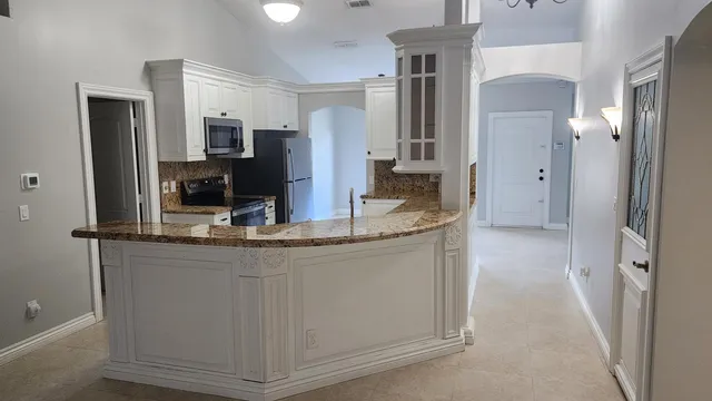 a bathroom with granite countertop a sink and a mirror