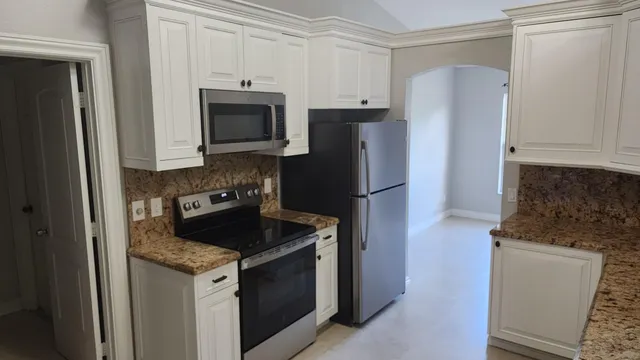 a kitchen with a refrigerator stove and microwave