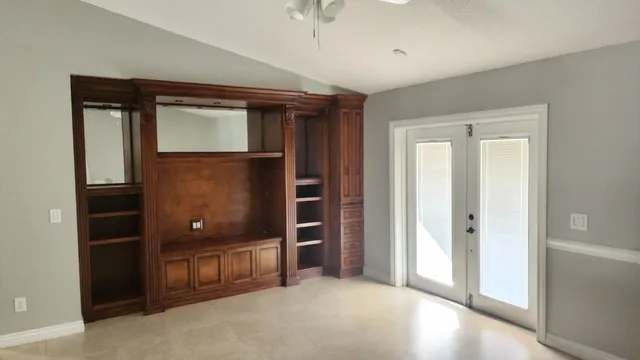 an empty room with closet and mirror