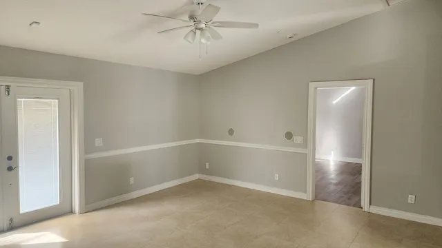 an empty room with a empty space and a ceiling fan
