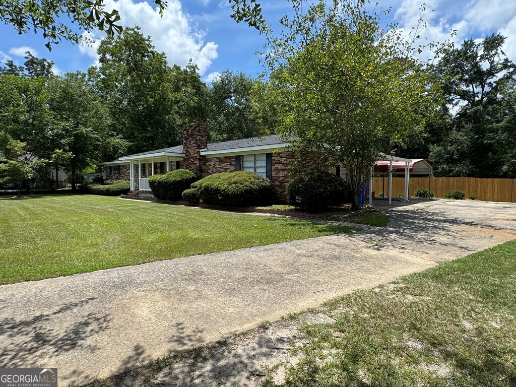 108 Plum Street Dublin, GA 31021 - Photo 4 of 33 a front view of a house with yard and green space
