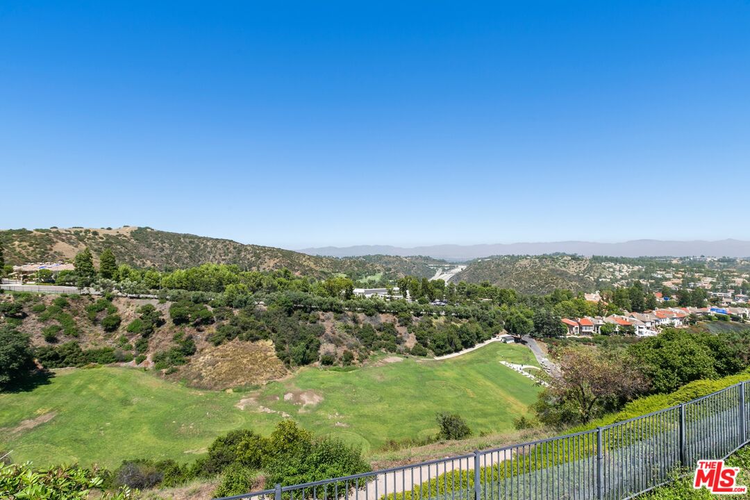 12519 Promontory Road Los Angeles, CA 90049 - Photo 10 of 10 a view of a city with lush green forest