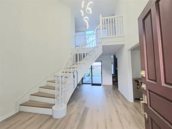 a view of entryway and hall with wooden floor