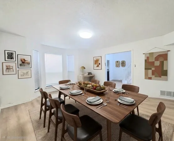 a dining room with wooden floor and breakfast area