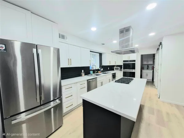 a kitchen with refrigerator and white cabinets
