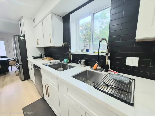 a kitchen that has a sink and a stove