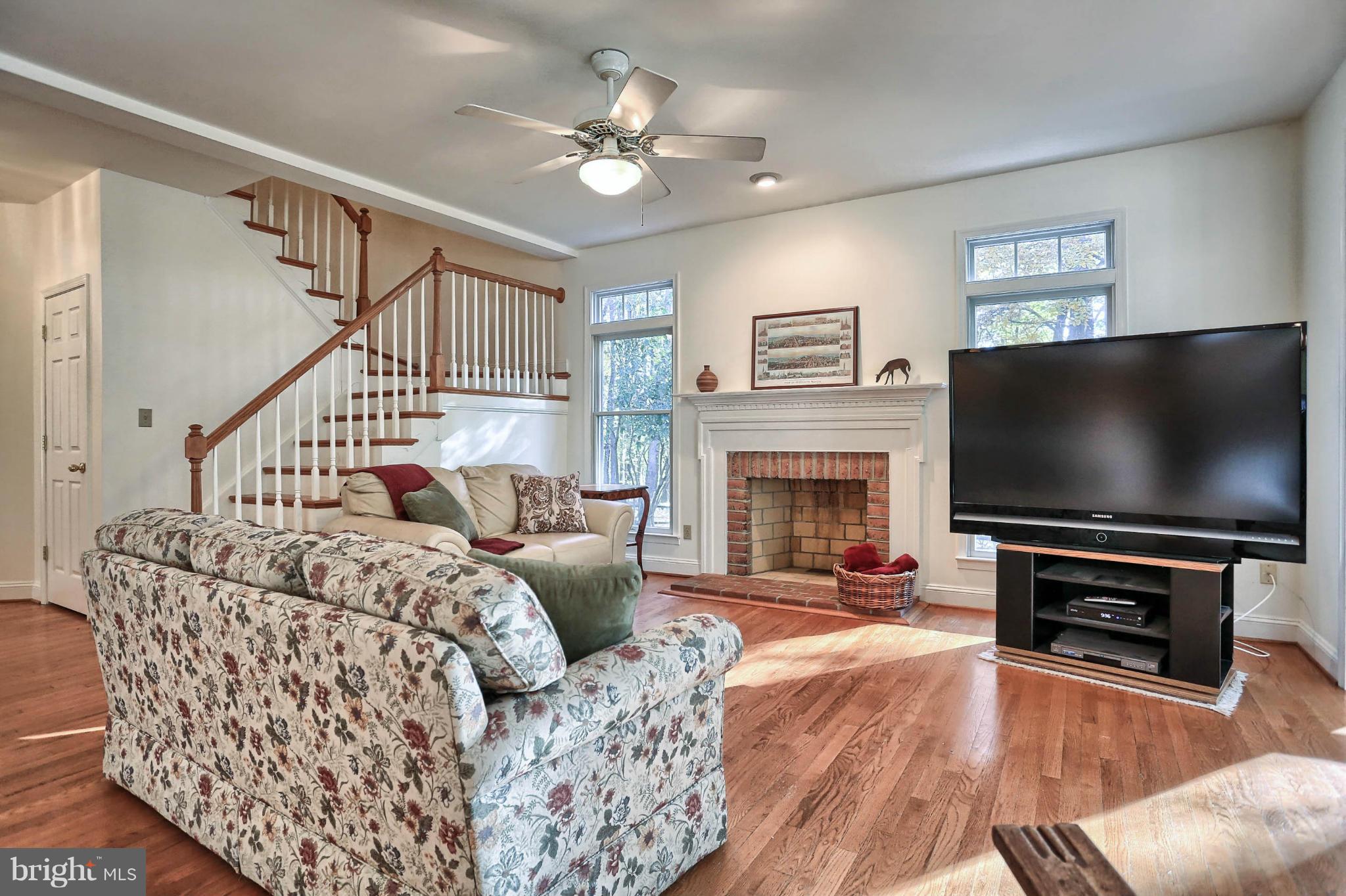 4905 Teen Barnes Road Frederick, MD 21703 - Photo 13 of 30 a living room with furniture a flat screen tv and a fireplace