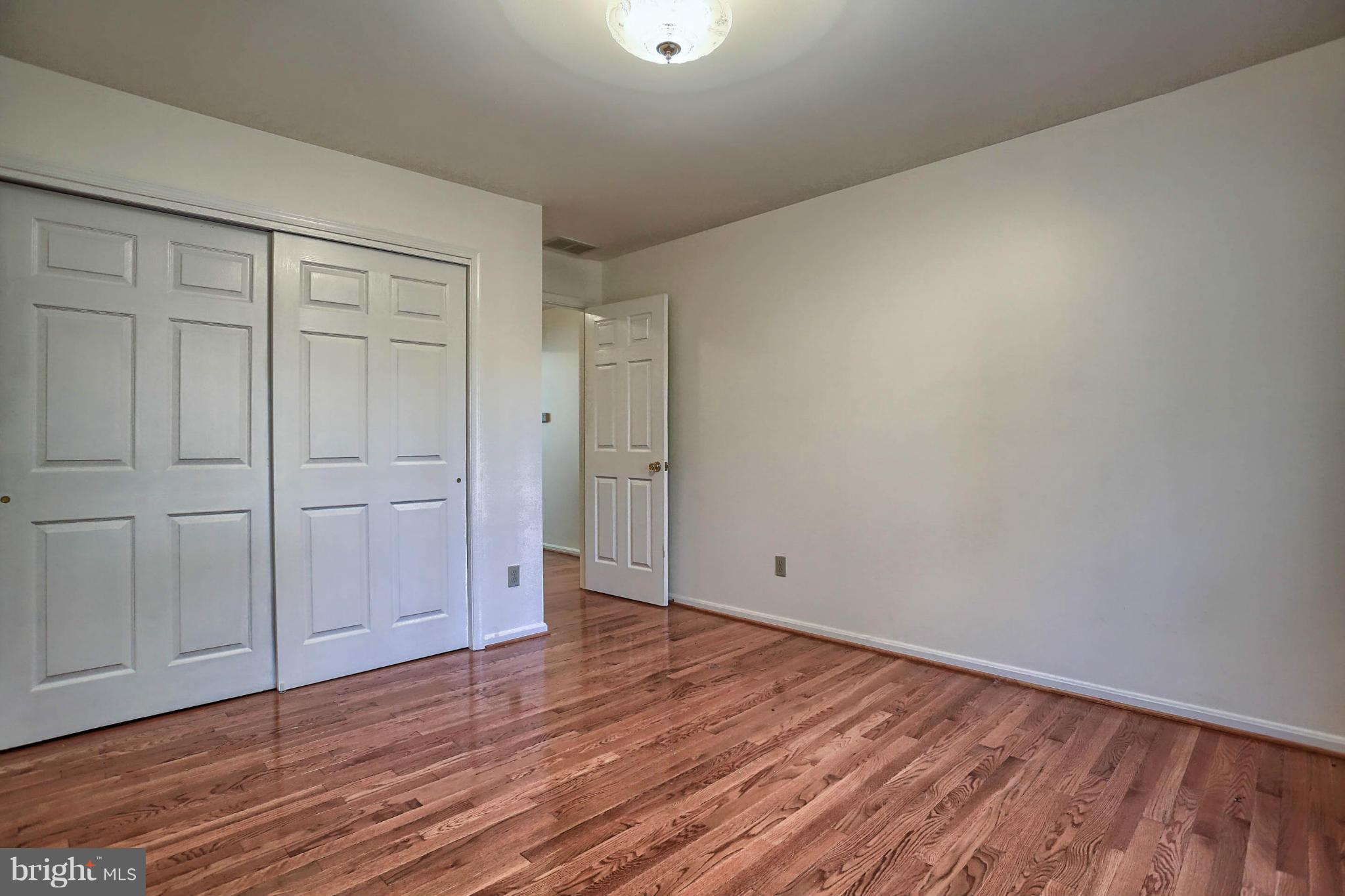 4905 Teen Barnes Road Frederick, MD 21703 - Photo 25 of 30 a view of an empty room with wooden floor