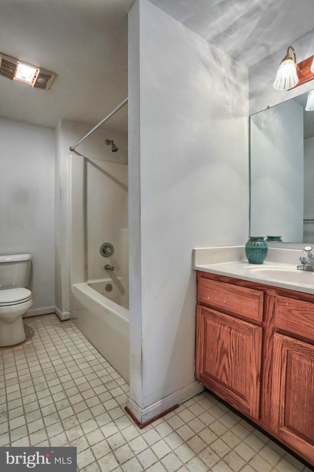 4905 Teen Barnes Road Frederick, MD 21703 - Photo 29 of 30 a bathroom with a granite countertop sink a toilet and bathtub