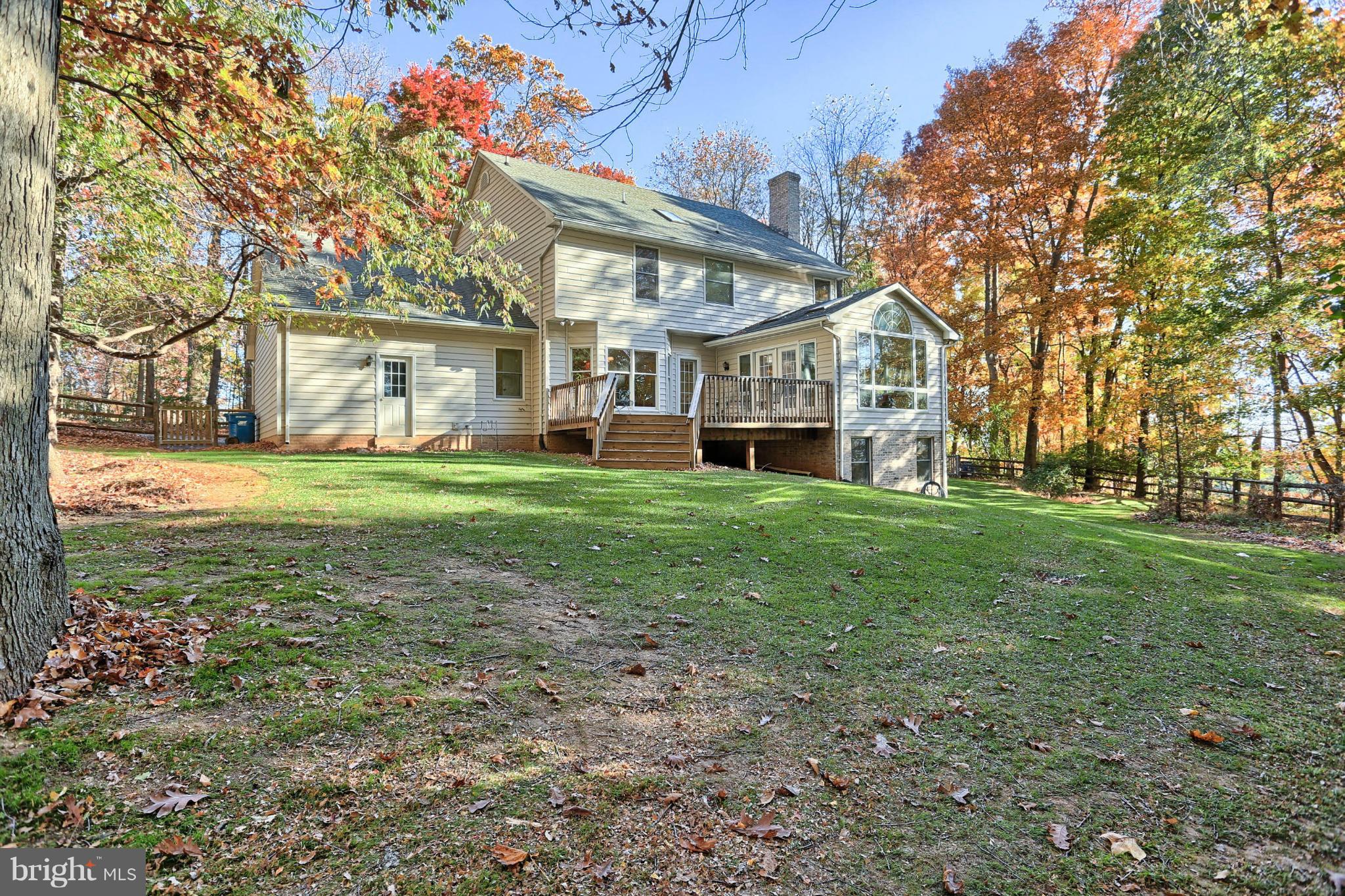 4905 Teen Barnes Road Frederick, MD 21703 - Photo 5 of 30 a view of a house with a big yard and large trees