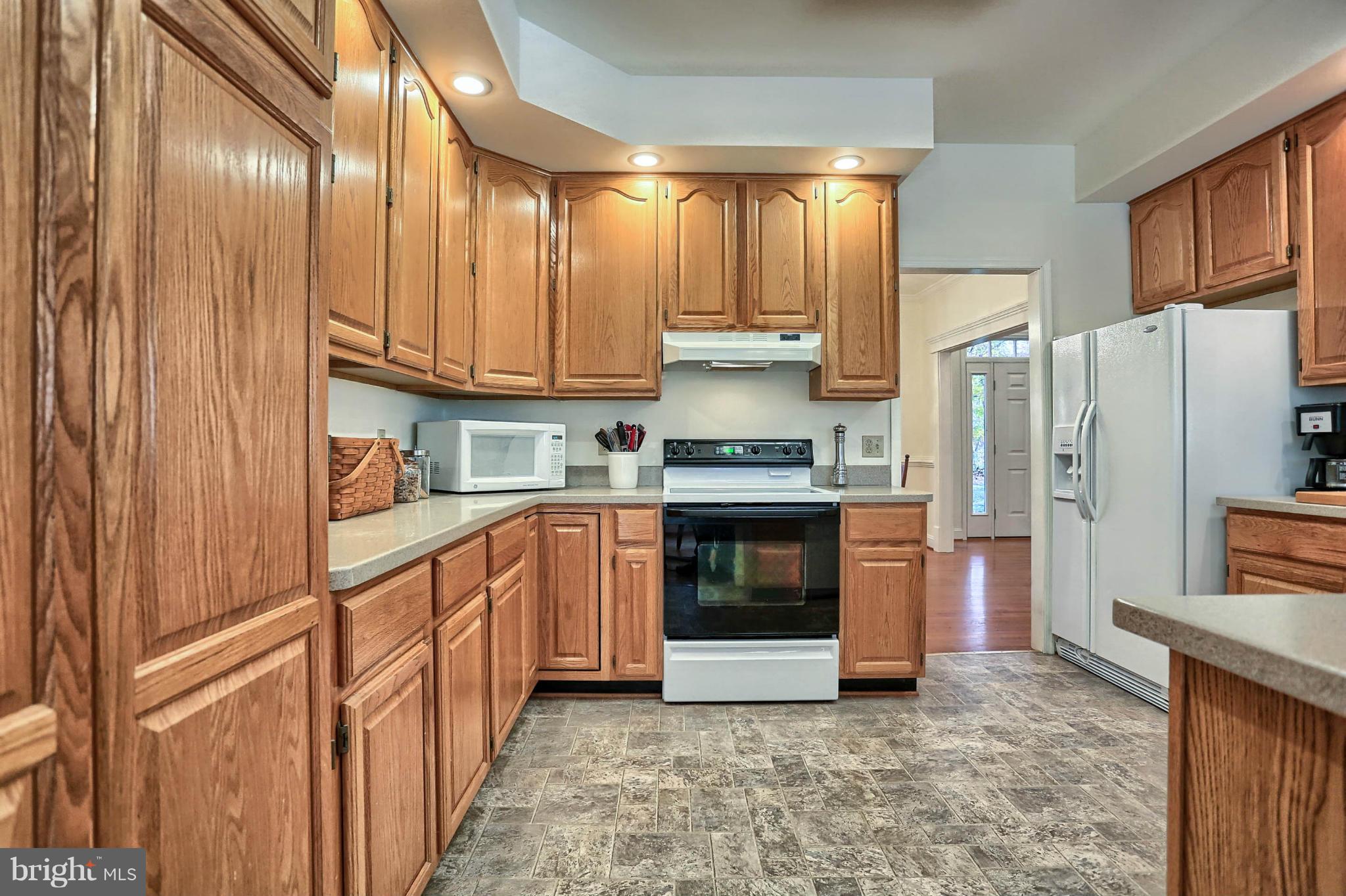 4905 Teen Barnes Road Frederick, MD 21703 - Photo 10 of 30 a kitchen with stainless steel appliances granite countertop a refrigerator a stove and a sink